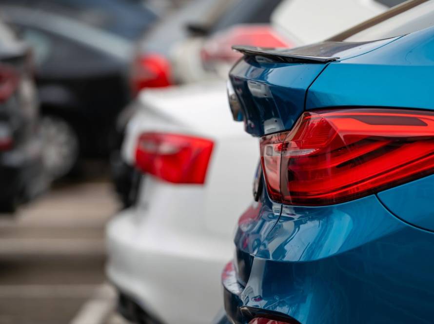 A zoomed in shot of the back of a blue BMW.
