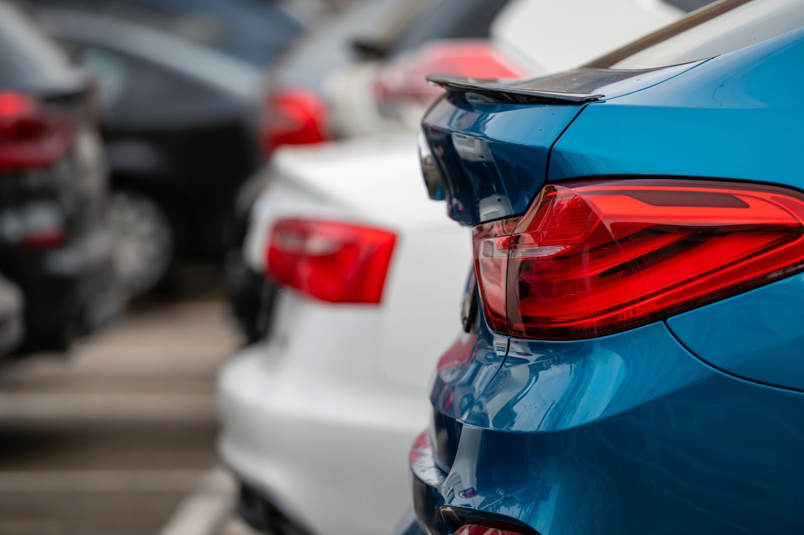 A zoomed in shot of the back of a blue BMW.