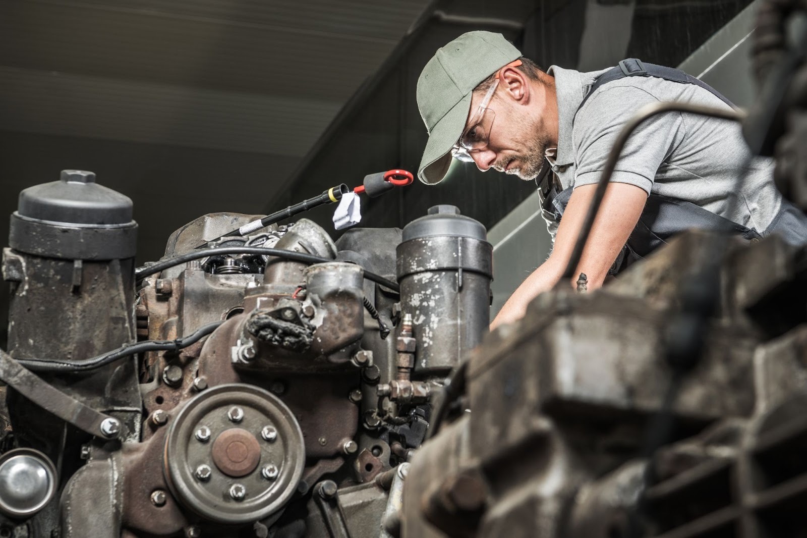 Skilled mechanic performing diesel engine restoration on a truck