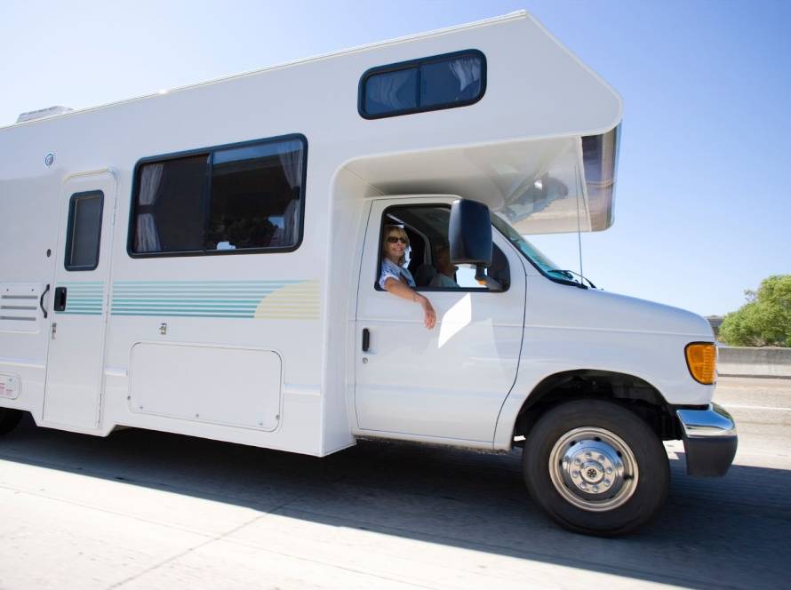 Side angle of a woman in sunglasses enjoying a bright day inside an RV