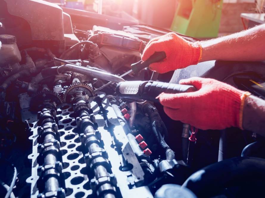 Detailed view of an auto repair specialist fixing a vehicle engine during service